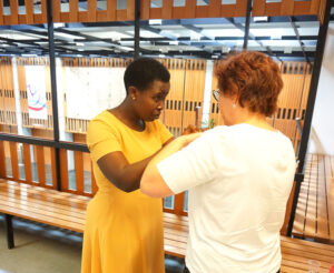 Two female participants communicating in tactile sign language