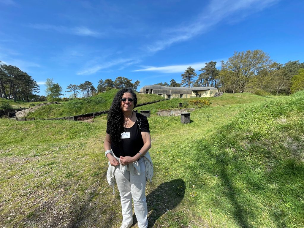 Suzy posing in a green field with a blue sky